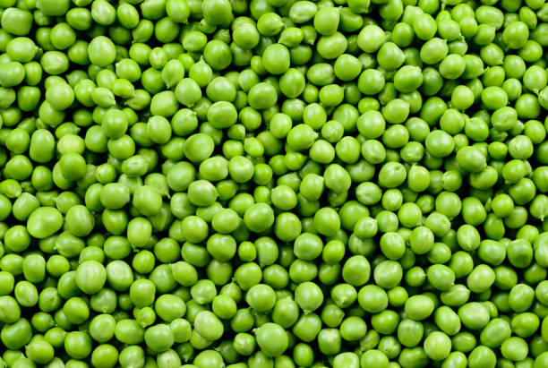 Green Peas. Green background. Peas background. Top view. Green Peas. Green background. Peas background. Top view. green pea photos stock pictures, royalty-free photos & images
