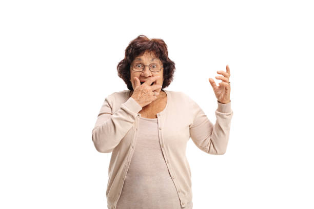 istock Surprised senior lady covering her mouth with her hand 881583096