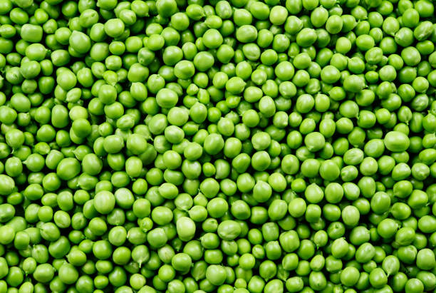 istock Green Peas. Peas background. Vegetable background. Top view. 881583338