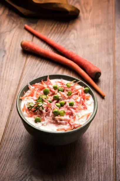 Carrot raita / Gajar  Koshimbir. It a condiment from the Indian subcontinent, made with dahi / curd together with raw / cooked vegetables Gajar / Carrot, green, peas, chilli, coriander