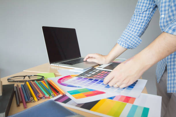 istock Designer graphic creative ,Man in blue shirt Working on laptop in  office with sunset background,Selective focus. 881584878