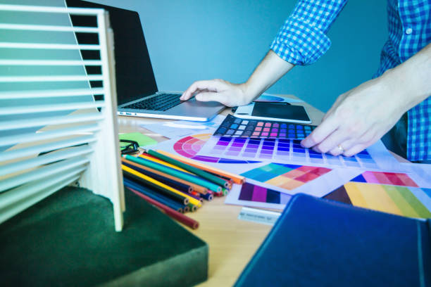 istock Designer graphic creative ,Man in blue shirt Working on laptop in  office with sunset background,Selective focus. 881585314
