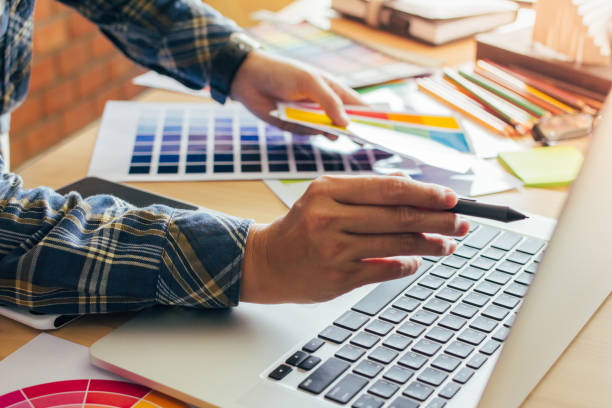 istock Designer graphic creative ,Man holding pen pointing Working on laptop in  office with sunset background,Selective focus. 881587012