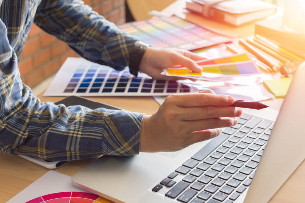 istock Designer graphic creative ,Man holding pen pointing Working on laptop in  office with sunset background,Selective focus. 881587052
