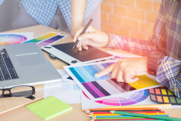 istock Designer graphic creative ,Man holding pen pointing Working on laptop in  office with sunset background,Selective focus. 881587060
