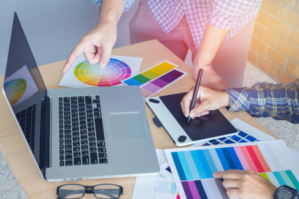 istock Designer graphic creative ,Man holding pen pointing Working on laptop in  office with sunset background,Selective focus. 881587062