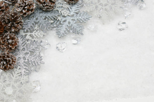 istock Silver Christmas snowflakes and pine cones nestled in ice 881591514