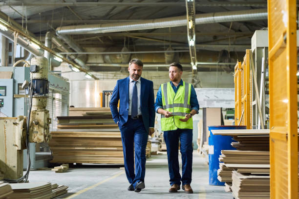 istock Mature Businessman Inspecting Modern Factory 881591840