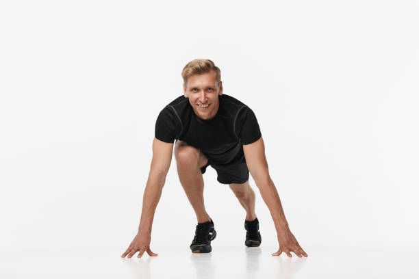 istock Smiling sportsman in crouch start on white 881598300