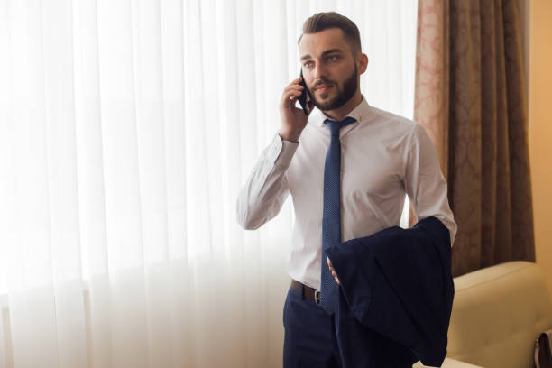 istock Handsome Businessman Calling from Hotel Room 881603828