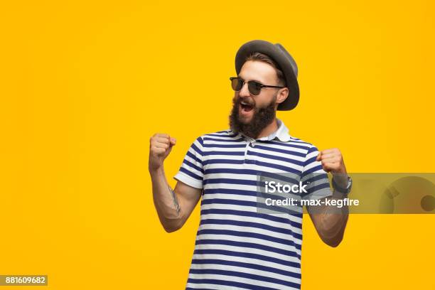 Excited Man Looking Victorious Stock Photo - Download Image Now - Colored Background, Arms Raised, Celebration