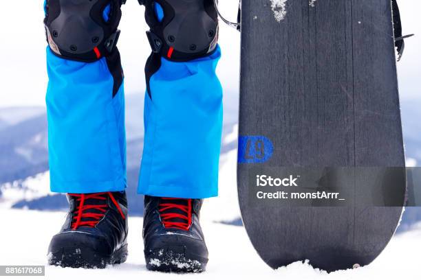 Legs In Snowboarder Boots With Snowboard Stock Photo - Download Image Now - Snowboard, Snowboarding, Boot