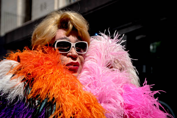In drag, a participant looks fabulous at Gay Pride Buenos Aires Sporting sunglasses, feathers, and faux fur; a participant at the Buenos Aires Gay Pride parade poses for a photo. fur protest stock pictures, royalty-free photos & images