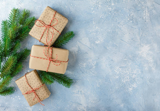 istock Christmas gift box and fir tree branch 881620086