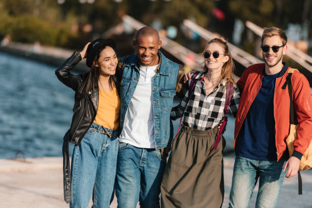 istock multicultural friends walking on pier 881621460