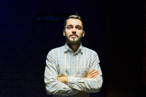 istock Contemporary Young Man in the Dark 881621656