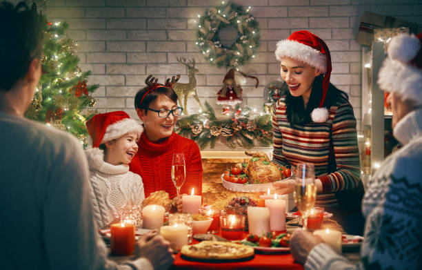 Family celebrates Christmas. Merry Christmas! Happy family are having dinner at home. Celebration holiday and togetherness near tree. family christmas party stock pictures, royalty-free photos & images