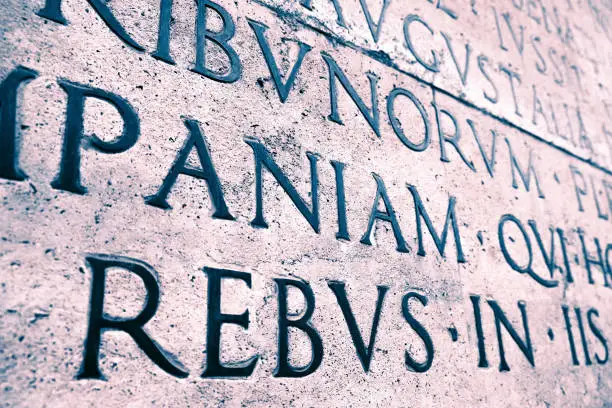 Latin inscription on the outside wall of the peace altar in Rome. Ara Pacis wall in Rome, Italy