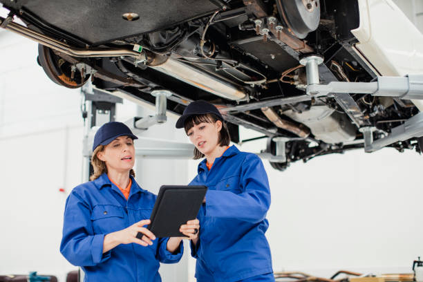 istock Female Mechanics Discussing Plans 881645582