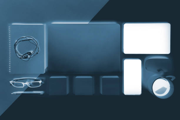 istock Flat lay x-ray photo of Office table with laptop computer, notebook, digital tablet, mobile phone, Pencil, eyeglasses  on modern two tone (white and grey) background. Desktop office mockup concept. 881648484