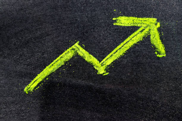 istock Green color hand drawing chalk in arrow up shape on black board background (Concept of revenue increase, stock or business growth) 881648624