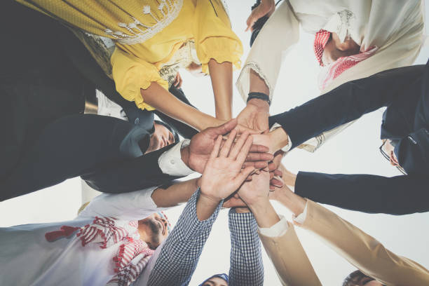 istock Group of business people joining hands. Team work concept. 881649188