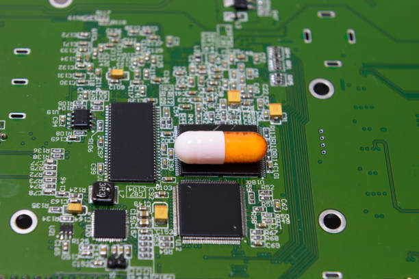 istock Blurred and selective focus of picture PCB circuit board and a pill on the PCB board.It indicates the developement of digital pill 881655164
