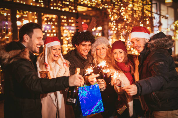 istock Friends Celebrating With Christmas Lighting Sparklers 881659714