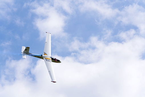 Plasy, Czech republic - April 30, 2017: Aerobatic two-seat all-metal Let L-13AC Blanik glider for dual aerobatic training fly on April 30, 2017 in Plasy, Czech republic. In United States Air Force Academy service is designated TG-10C and is used for basic flight training.