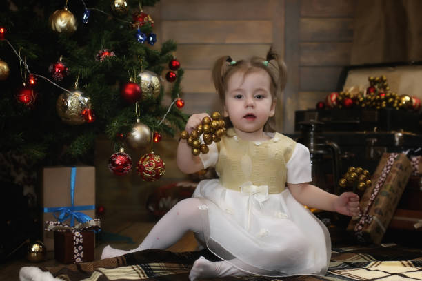 istock hild is sitting with Christmas decorations 881671972