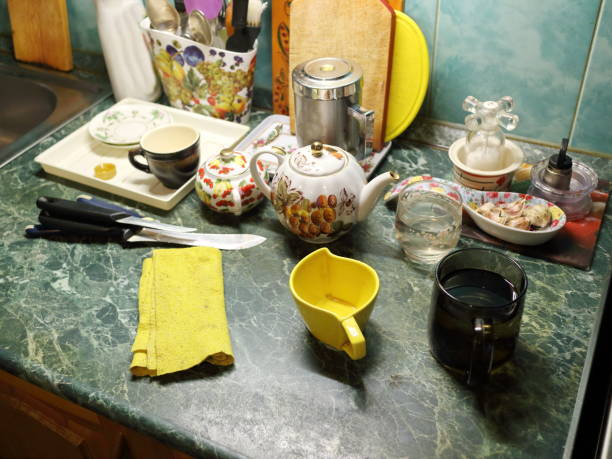 istock kitchen table with cups, a kettle, knives and a dresser 881687774