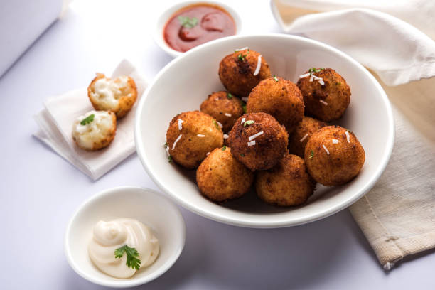 istock Fried potato cheese balls or croquettes with tomato ketchup. Selective focus 881693326