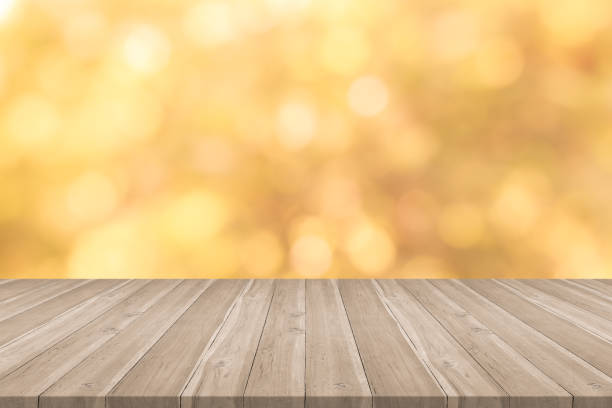 istock Empty wooden table top on yellow blurred background,space for montage products 881693642