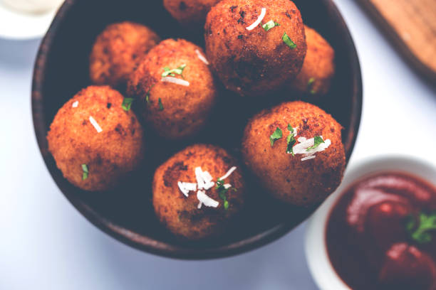 istock Fried potato cheese balls or croquettes with tomato ketchup. Selective focus 881693650