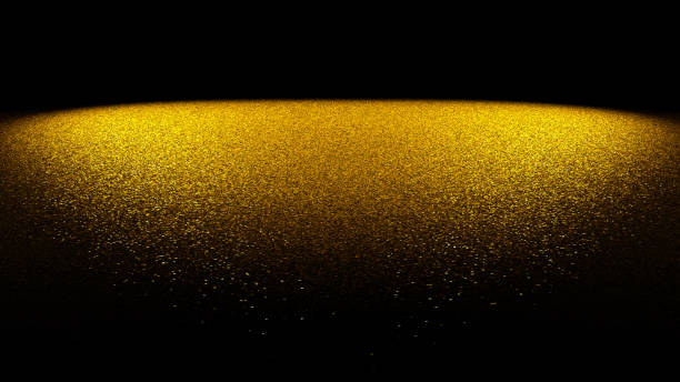 istock festive glitter background - golden glitter on a flat surface lit by two spotlights in front of a black background 881693708