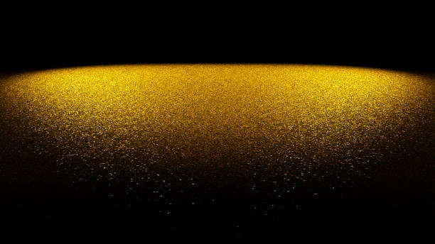 fundo festivo brilho - glitter dourado em uma superfície plana, iluminado por dois focos na frente de um fundo preto - gold bright brightly lit light - fotografias e filmes do acervo