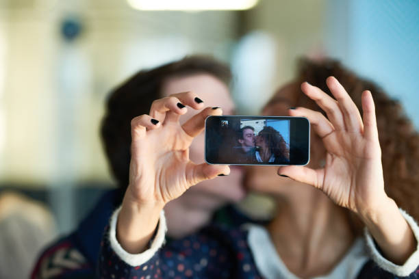 istock Passionate couple kissing for selfie 881698688