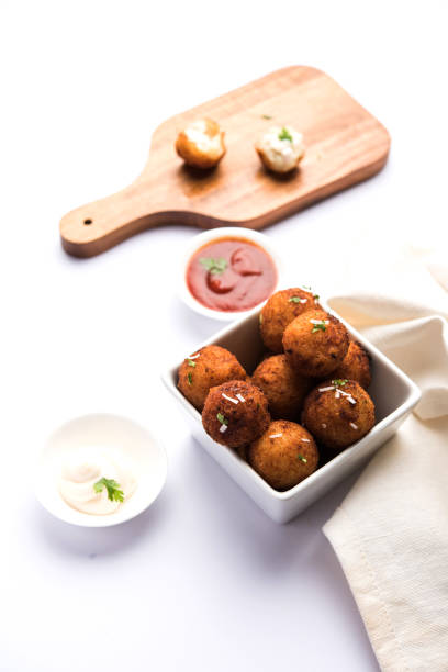 istock Fried potato cheese balls or croquettes with tomato ketchup. Selective focus 881699854