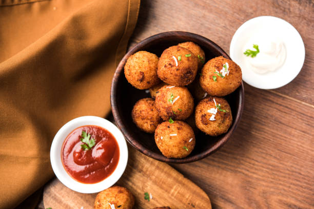 istock Fried potato cheese balls or croquettes with tomato ketchup. Selective focus 881707084