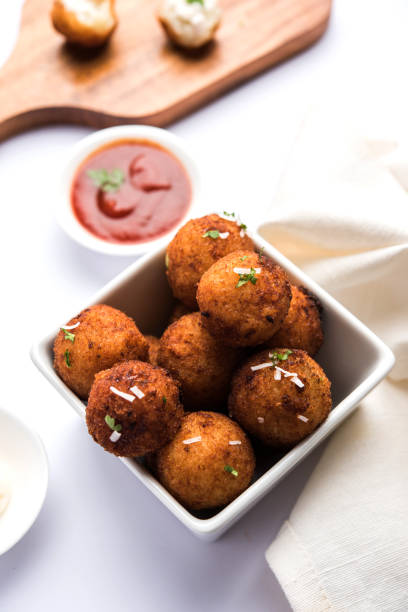 istock Fried potato cheese balls or croquettes with tomato ketchup. Selective focus 881707552