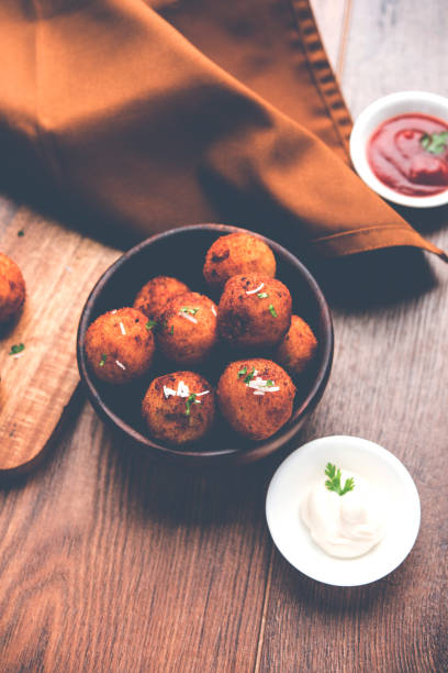 istock Fried potato cheese balls or croquettes with tomato ketchup. Selective focus 881712080