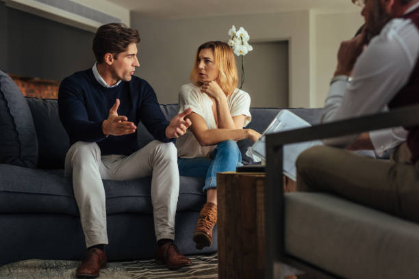 istock Couple arguing during therapy session with psychologist 881712964