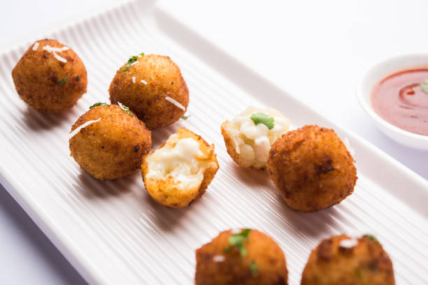 istock Fried potato cheese balls or croquettes with tomato ketchup. Selective focus 881712966