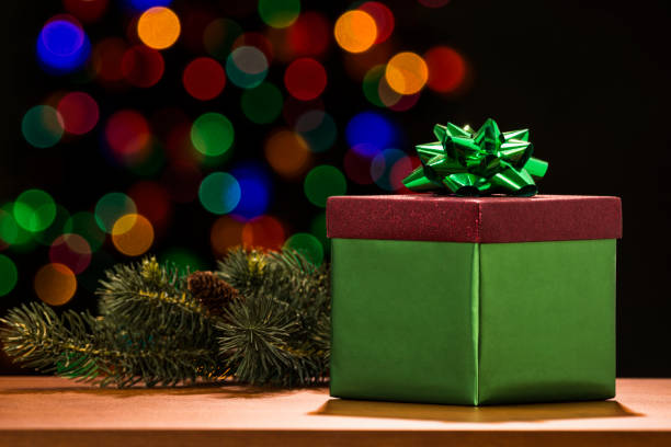 istock Red and green gift box with bokeh from a Christmas tree. 881716262