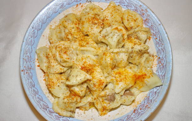 istock dumplings in a plate with red pepper and butter 881716698
