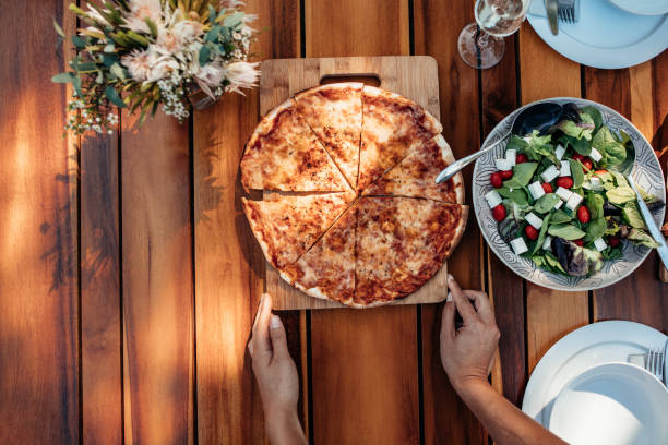 istock Female hands setting food on the table 881719304