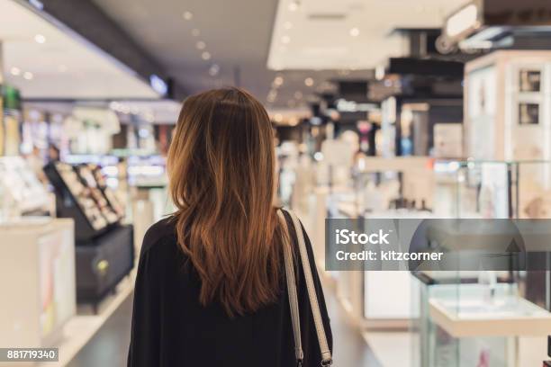 Young Asian Woman Walking In Cosmetics Department At The Mall Stock Photo - Download Image Now