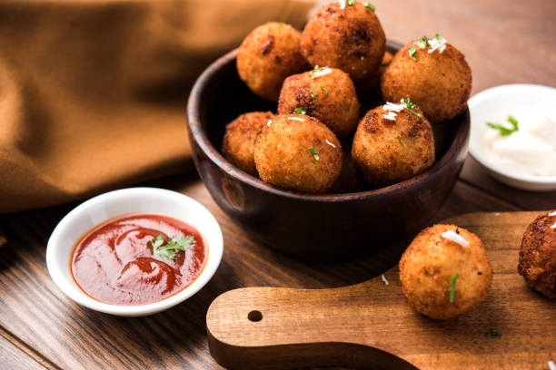 Fried potato cheese balls or croquettes with tomato ketchup. Selective focus