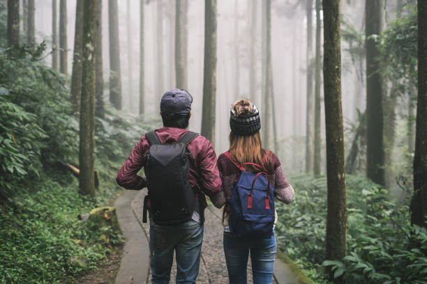 istock Young couple traveler with backpack holding hand together 881720348