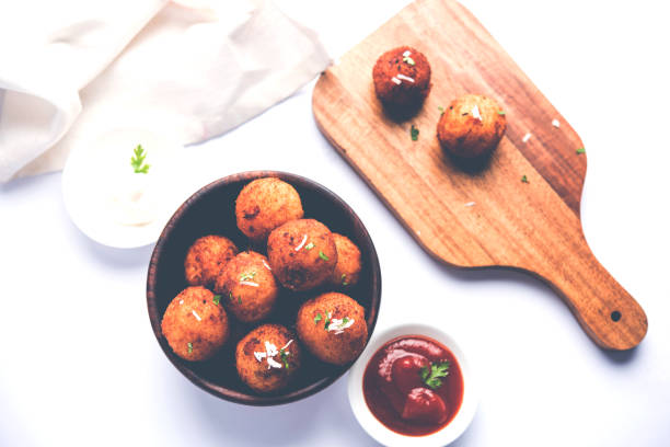 istock Fried potato cheese balls or croquettes with tomato ketchup. Selective focus 881721216